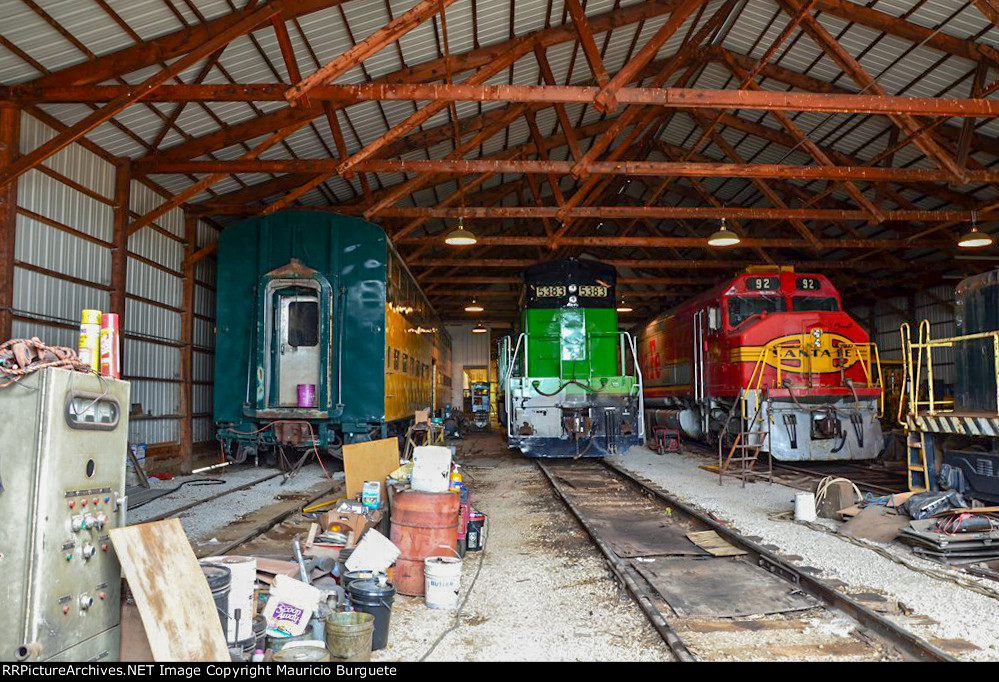 Diesel locomotives inside the barn and a CNW Cab car 